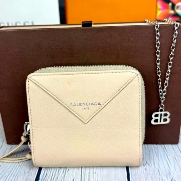 Balenciaga cream leather compact wallet bifold zippy and charm necklace.…